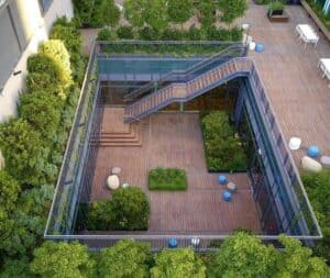 A rooftop garden with חיפוי במבוק, wooden decking, greenery, and blue and white seating areas features a central sunken patio accessed by stairs.